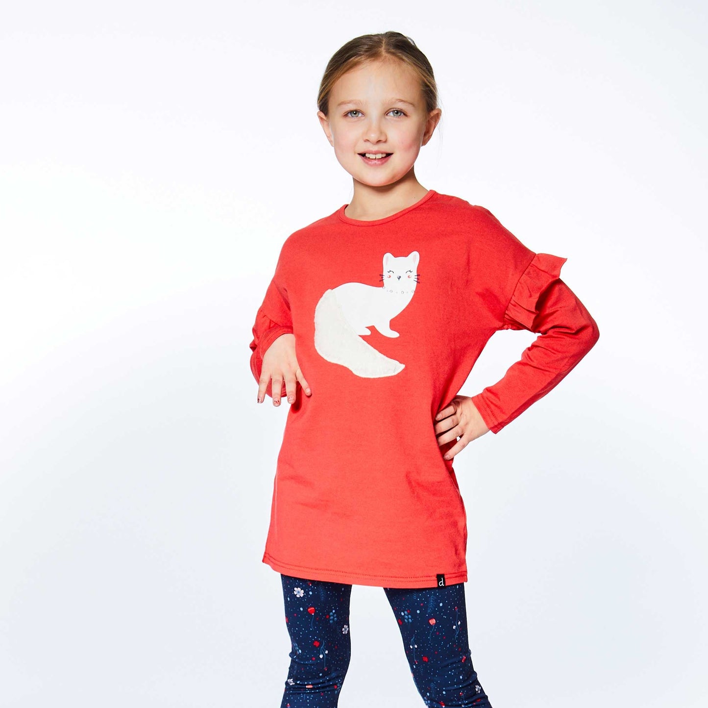 Ruffled sleeves lend playful charm to our Long Sleeve Tunic With Red Frill. This long sleeve top is made from a soft cotton/elastane blend.  Features dropped shoulders, a round neckline, and an adorable weasel print and applique on the chest.