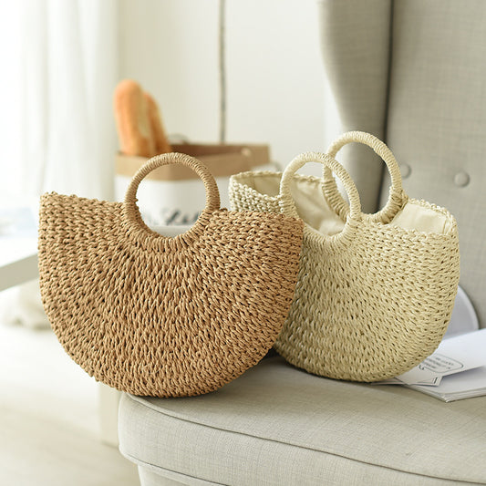 Half Moon Handmade Straw Handbags. These beautiful bags are woven by hand and feature a unique moon-shaped top handle.