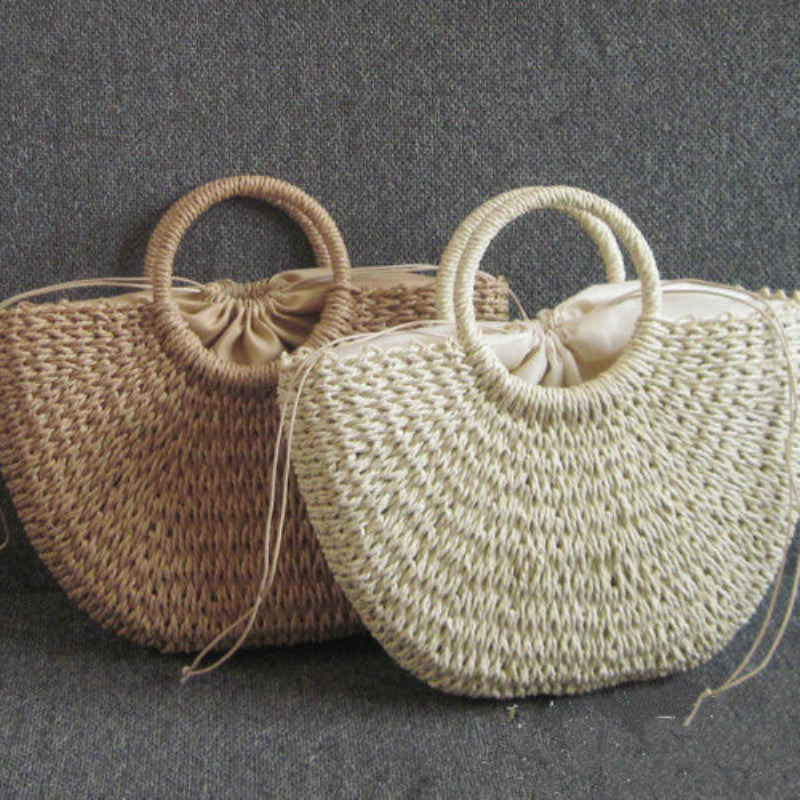 Half Moon Handmade Straw Handbags. These beautiful bags are woven by hand and feature a unique moon-shaped top handle.