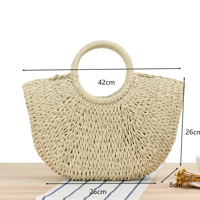 Half Moon Handmade Straw Handbags. These beautiful bags are woven by hand and feature a unique moon-shaped top handle.