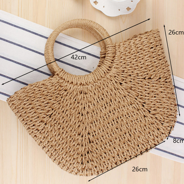 Half Moon Handmade Straw Handbags. These beautiful bags are woven by hand and feature a unique moon-shaped top handle.