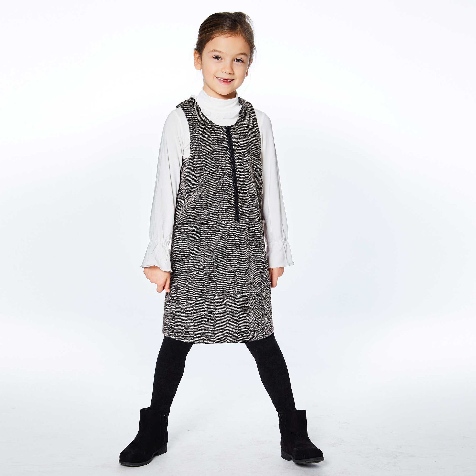 Sleeveless with a front zipper, our Herringbone Jumper With Pocket Black is easy to layer over any top or bodysuit. This jumper dress features wide, flat straps, a scoop neckline, and two patch pockets on the front.