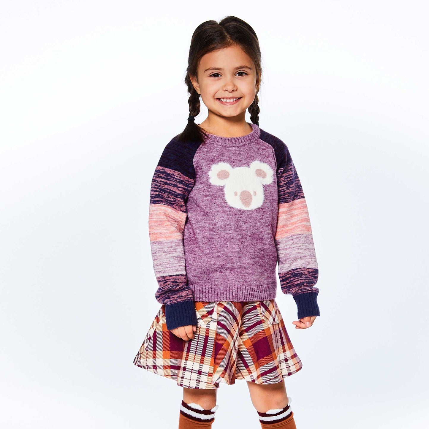 The Long Sleeve Knitted Koala Sweater features long raglan sleeves with space dyed stripes, a crew neckline, and a solid body with an adorable koala face on the front.  A koala bear face on the chest makes this pullover sweater simply perfect for a chilly day! 