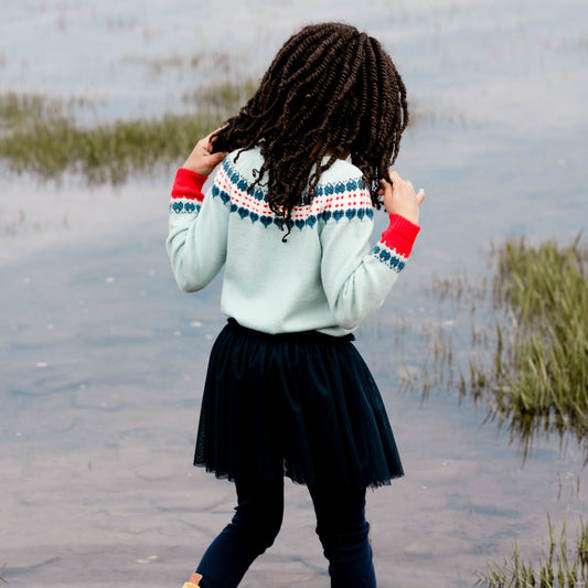 A Fair Isle pattern adds ski-inspired style to our Long Sleeve Knitted Sweater Light Blue and Red.  This pullover sweater is made from an acrylic/nylon/poly blend and features long raglan sleeves, a round neckline, and a Nordic pattern across the chest and sleeves. A rib knit hem and contrast cuffs complete the look!