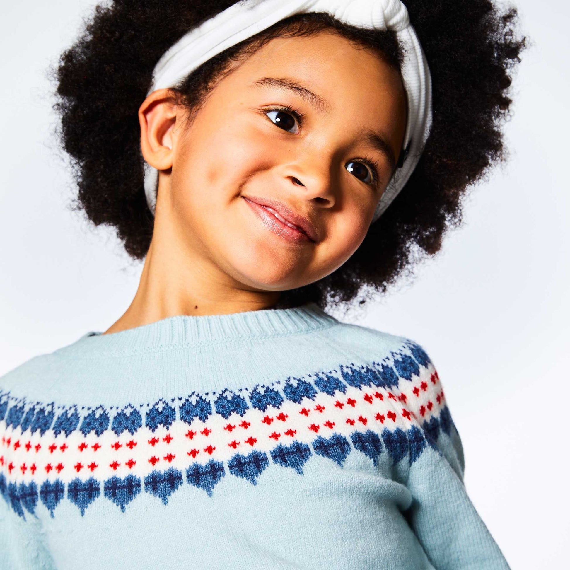 A Fair Isle pattern adds ski-inspired style to our Long Sleeve Knitted Sweater Light Blue and Red.  This pullover sweater is made from an acrylic/nylon/poly blend and features long raglan sleeves, a round neckline, and a Nordic pattern across the chest and sleeves. A rib knit hem and contrast cuffs complete the look!