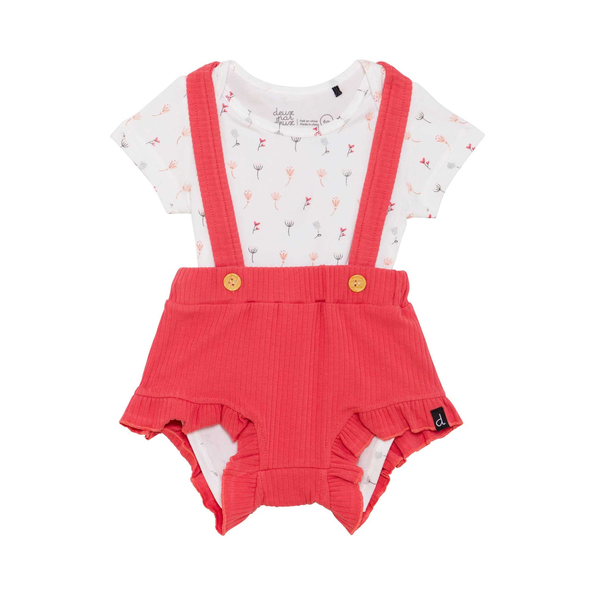 Overalls with button straps add playful style to our Organic Cotton Bodysuit and Bloomer Set, The bloomers layer over a floral print bodysuit with short sleeves and a round neckline.  This adorable two-piece set features a solid rib knit bloomer short with ruffle trim and slender straps that crisscross in back.