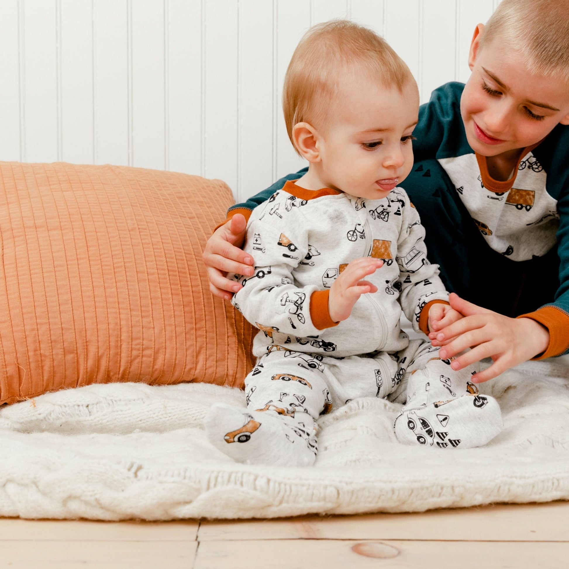 Little ones can lounge, play, and sleep in style in our Organic Cotton One Piece Printed Pajamas With Printed Automobiles.  This ultra-soft one-piece footie pajama features long sleeves, a round neckline, an asymmetrical zipper closure, and an allover print of cars, buses, and bikes.