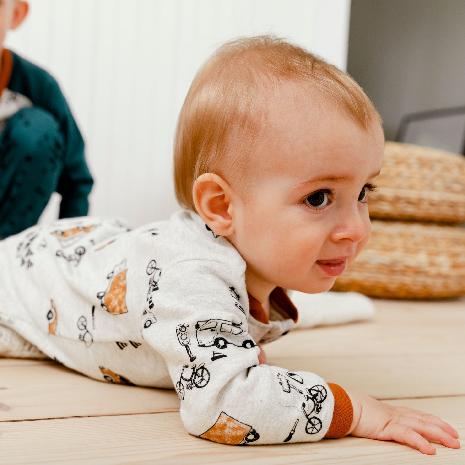 Little ones can lounge, play, and sleep in style in our Organic Cotton One Piece Printed Pajamas With Printed Automobiles.  This ultra-soft one-piece footie pajama features long sleeves, a round neckline, an asymmetrical zipper closure, and an allover print of cars, buses, and bikes.