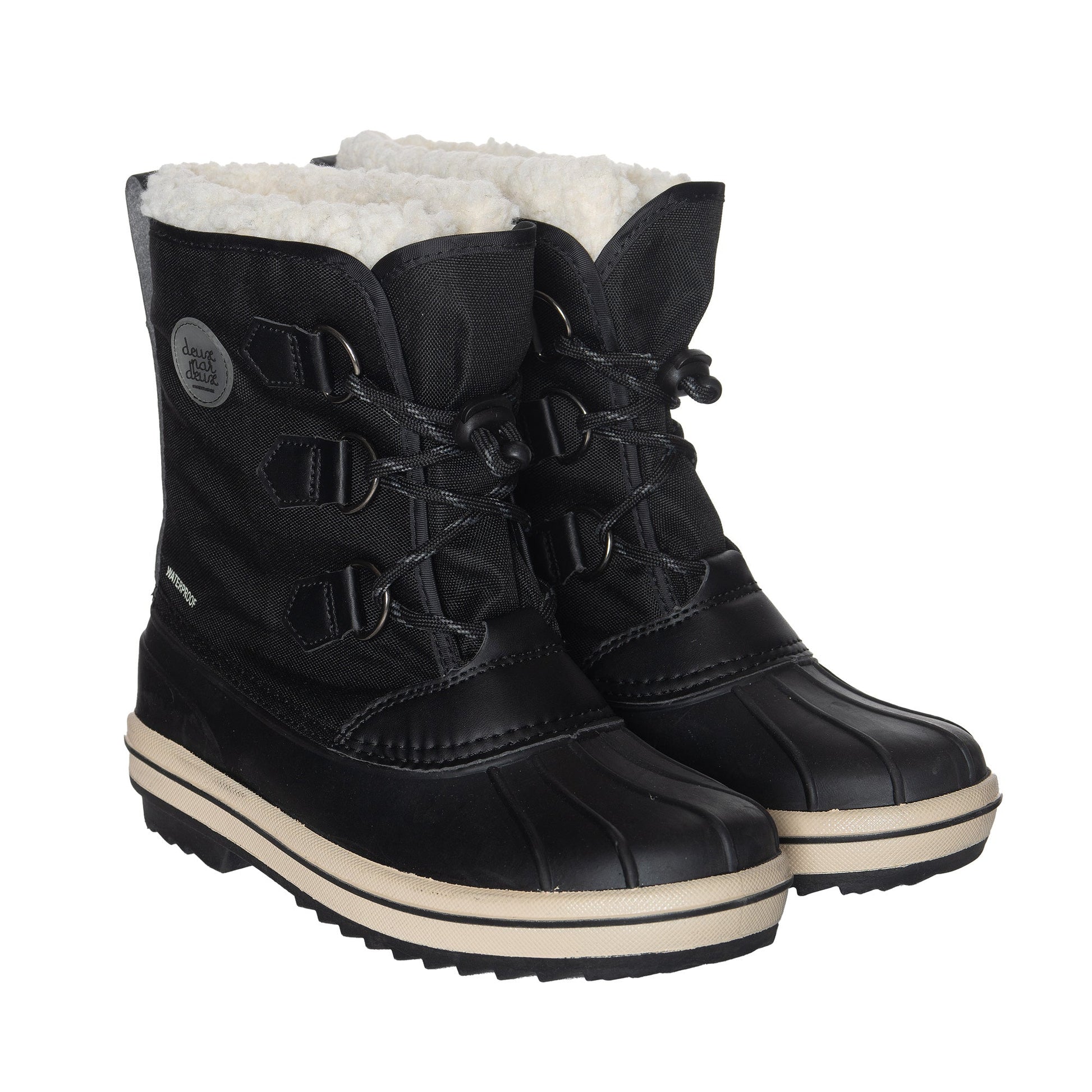 Protect your little one's tootsies on a cold day with our Winter Boots Black. Made from soft acrylic, these boots are the perfect way to keep the feet warm, and the neutral color makes them a cinch to pair with any outfit.